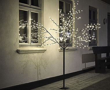 YGGDRASIL világító fa egy ház ablaka alatt kültéren