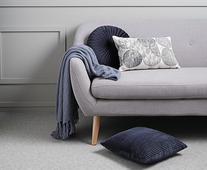 Sofa with throw and sofa cushions 