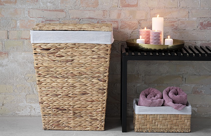 EGIL laundry basket and SAUNTE bench with candles in a bathroom. EJNO basket with towels Laundry basket and bench with candles in a bathroom. Basket with towels