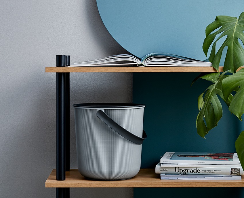 Storage bucket AKITA with a lid and a handle on a shelf a TEGLUM bookcase Storage bucket with a lid and a handle on a shelf a bookcase