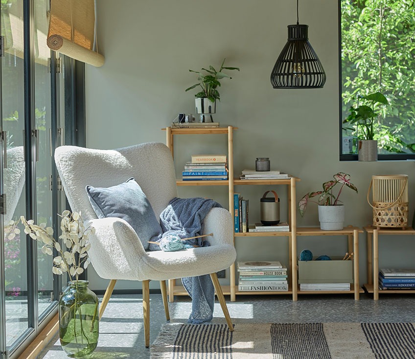 HUNDESTED armchair, VANDSTED room divider, FELIX floor vase and KARLSSON black pendant Grey armchair by a window with a green floor vase and a bamboo room divider in the background