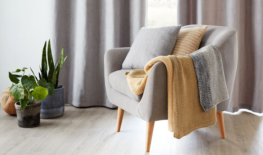 Cosy armchair with throws and cushions